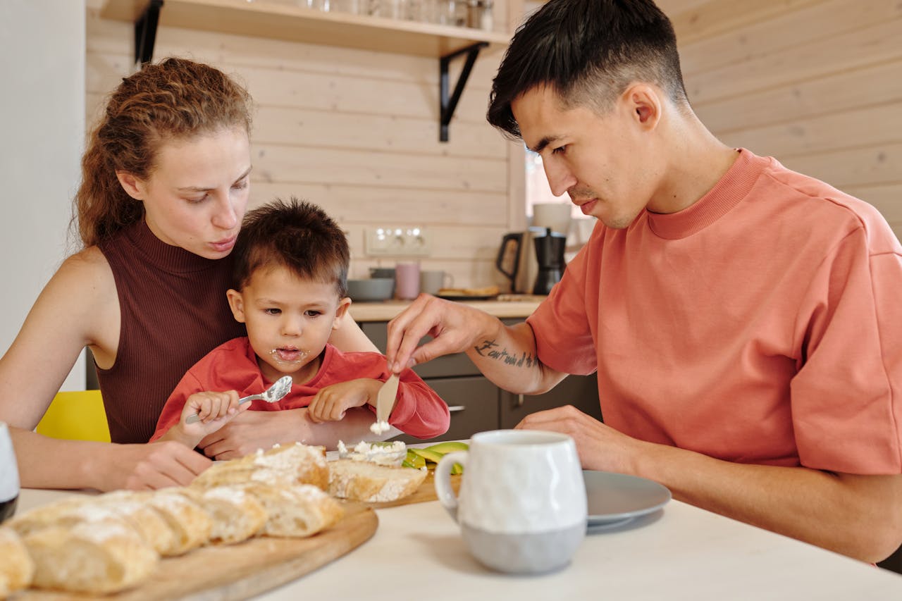 Parents and child bonding over breakfast indoors, capturing family togetherness.